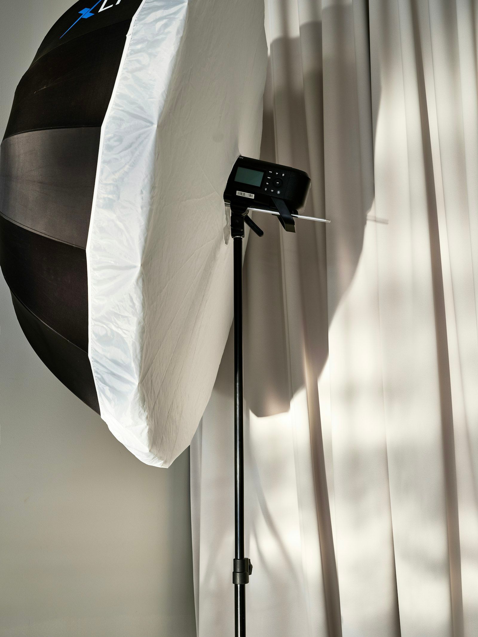 Photography studio with softbox lighting rig glowing against a dark backdrop
